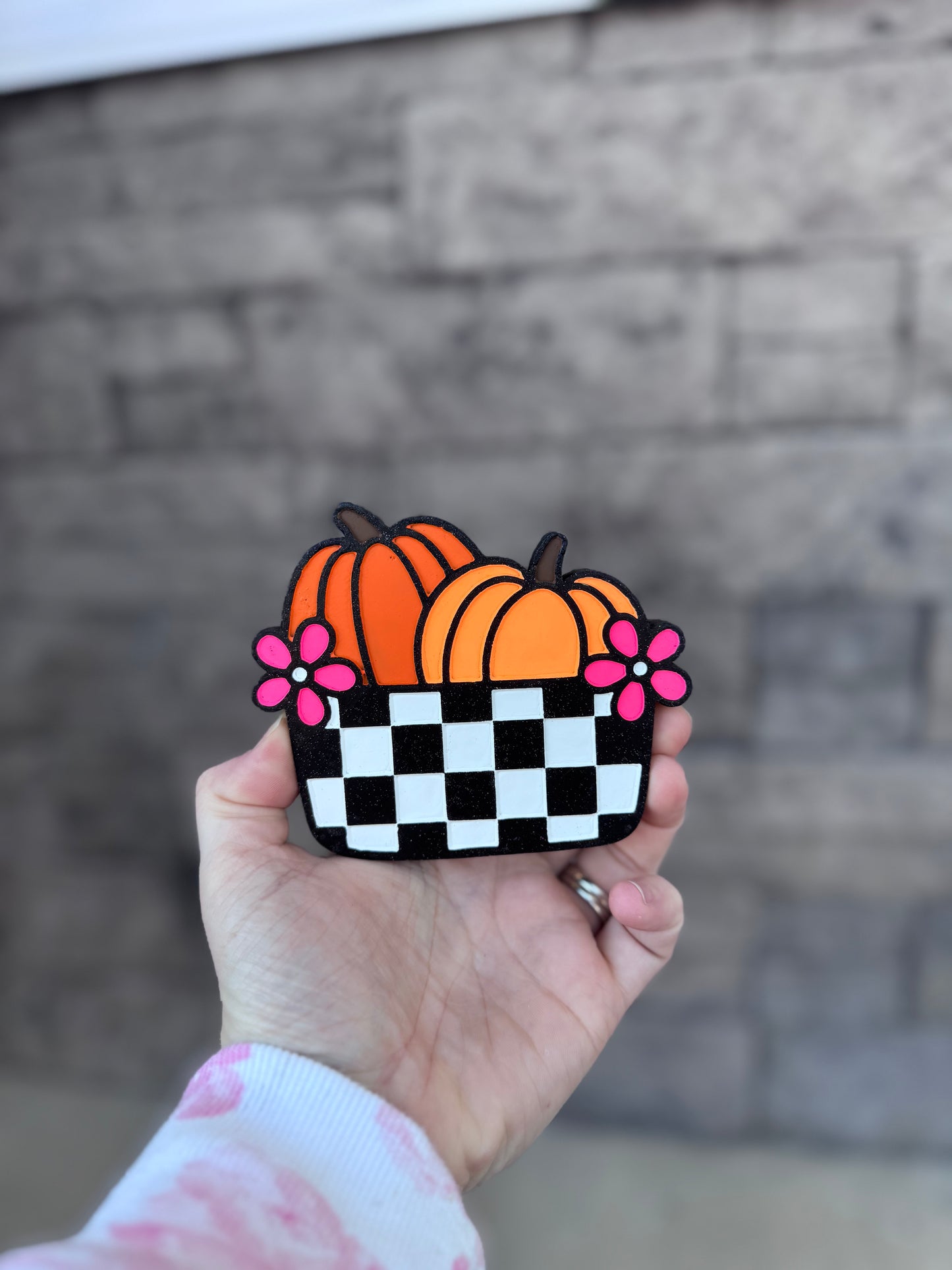 Pumpkin in checkered bucket