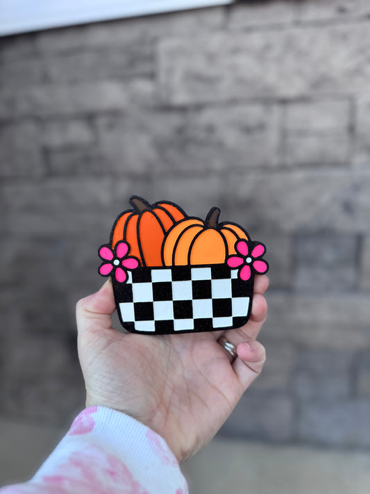Pumpkin in checkered bucket
